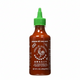 Bottle of Sriracha hot chili sauce with a green cap on a white background, featuring the brand logo.