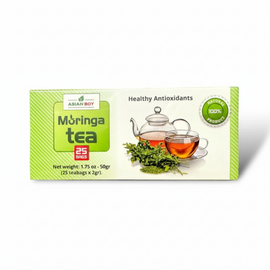 Box of Asian Boy Moringa tea with teacup and tea leaves on a white background